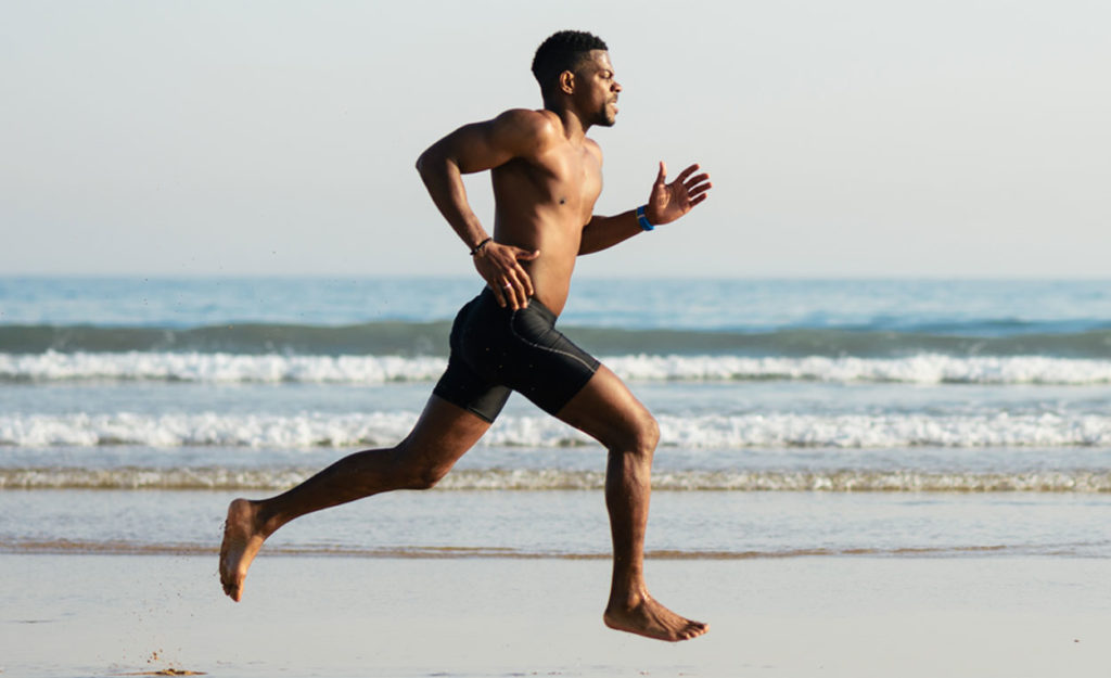 Healthy man running on the beach