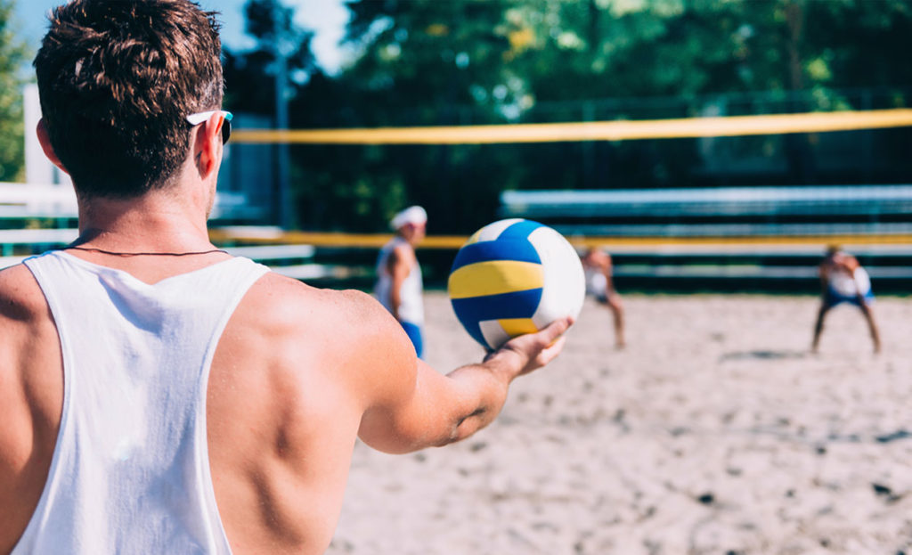 Healthy men playing vollyball
