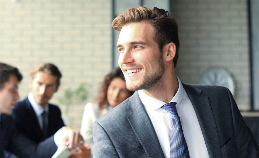 Happy Man Smiling in a business suit at a meeting